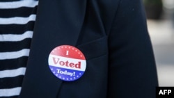 Lisa O. wears an "I Voted Today!" sticker after casting her vote during early voting at City Hall in Philadelphia, Pennsylvania on October 7, 2020. (Photo by GABRIELLA AUDI / AFP)