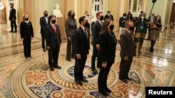 House impeachment managers stand at the U.S. Capitol to hand-carry an article of impeachment against former President Donald Trump to the Senate for trial on accusations of inciting the January 6 attack on the Capitol, in Washington, U.S., January 25, 202