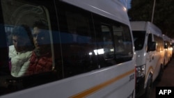 Asylum seekers waiting for their CBP One appointments with U.S. authorities to resume, take a van to be transported to a shelter at El Chaparral port in Tijuana, Baja California state, Mexico, on Jan. 20, 2025.