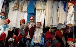 FILE - Dolls dressed in the traditional clothes are displayed at a clothing store at the Medina of Tunis, Tunisia, September 25, 2018. (REUTERS/Zoubeir Souissi)