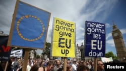 Protestors hold banners in Parliament Square during a 'March for Europe' demonstration against Britain's decision to leave the European Union, central London, Britain, July 2, 2016. 