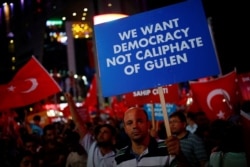 FILE - Banners and flags are waved at a solidarity rally nearly two weeks after a failed attempted coup in Ankara, Turkey, July 27, 2016.