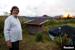 Homeowner Victor Hoapili stands on his property as lava erupts from a fissure in the Leilani Estates near Pahoa, Hawaii, May 23, 2018.