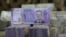 FILE - Syrian pounds are pictured inside an exchange currency shop in Azaz, Syria, Feb. 3, 2020. Rising prices and a drop in the currency's value have pushed ordinary Syrians to vent their anger in recent protests.