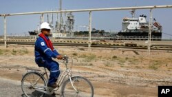 دیمەنی تێپەڕینی ئەندازیارێک لە نزیک یەکێک لەو کەشتییە بارهەڵگرانەی بۆ گواستنەوەی گازی سروشتی عێراق لە ئوم قەسر دابینکراوە، لە مانگی سێی ساڵی 2016.