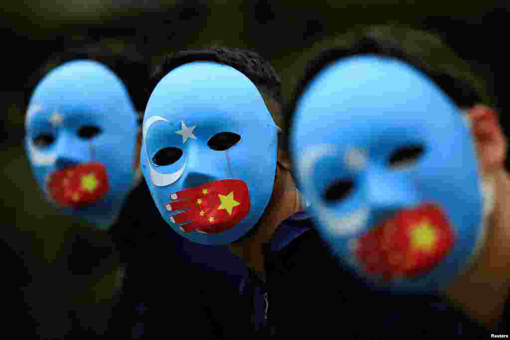 Activists take part in a protest against China's treatment toward the ethnic Uyghur people and calling for a boycott of the 2022 Winter Olympics in Beijing, at a park Jakarta, Indonesia.