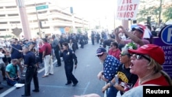 Pro Trump supporters face off with peace activists during protests outside a Donald Trump campaign rally in Phoenix, Ariz., Aug. 22, 2017.