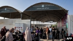 Watu wakisubiri katika kivuko cha mpakani eneo la Rafah linalopakana na Misri kusini mwa Ukanda wa Gaza, November 1, 2023.