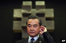 Chinese Foreign Minister Wang Yi gestures as he answers questions from reporters as he attends the 50th ASEAN Foreign Ministers' Meeting and its dialogue partners in Manila, Philippines, Aug. 6, 2017.