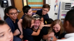 Joe Emery, TAC*ONE trainer and former Las Vegas police department sergeant, is swarmed by fifth grade students in a shooter take down exercise at Pinnacle Charter School during TAC*ONE training for an active shooter situation in a school in Thornton, Colo
