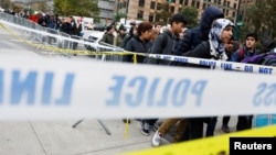 Students walk past police line tape on their way to school a day after a man driving a rented pickup truck mowed down pedestrians and cyclists on a bike path alongside the Hudson River in New York City, Nov. 1, 2017. 