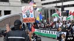 Protesters wave Palestinian flags during a protest to demand reproductive rights, defend the rights of LGBTQ people and demand a ceasefire in Gaza on the eve of the Democratic National Convention at the United Center in Chicago, Illinois, on Aug. 18, 2024.
