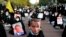 Iranian protesters hold defaced pictures of French President Emmanuel Macron during a protest against the publishing of caricatures of the Prophet Muhammad they deem blasphemous, in front of French Embassy in Tehran, Oct. 28, 2020. (AP/Ebrahim Noroozi)
