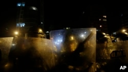 FILE - Ecuadorian police in riot gear. Ecuador's president, Rafael Correa, declared a 30-day state of emergency in Morona Santiago province, home to the Panantza-San Carlos exploration project operated by the ExplorCobres company. His government said "illegally armed groups" protested against the project on Wednesday.