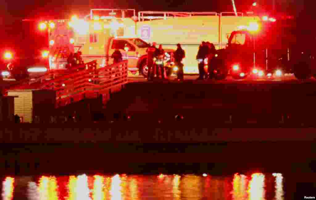 Emergency personnel work near the site of the crash after American Eagle flight 5342 collided with a Black Hawk helicopter while approaching Reagan Washington National Airport and crashed into the Potomac River, outside Washington, Jan. 30, 2025. 