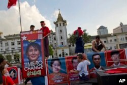 Supporters of Myanmar's opposition leader Aung San Suu Kyi's National League for Democracy party decorate the back of a truck for a campaign rally to conclude their election campaign in Yangon, Myanmar, Nov. 5, 2015.