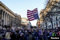 Demonstrators rally outside the Treasury Department after it was reported billionaire Elon Musk has gained access to the U.S. Treasury's federal payments system in Washington, Feb. 4, 2025.