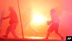 A so-called "deactivator" and "front-line" activist, face off with police during an anti-government protest in Lima, Peru, Jan. 28, 2023.
