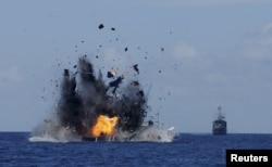 The Indonesian navy scuttles foreign fishing vessels caught fishing illegally in Indonesian waters near Bitung, North Sulawesi, May 20, 2015. A total of 19 foreign boats from Vietnam, Thailand, Philippines and one from China were destroyed.