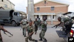 Government military officers runs outside the air-force base near the airport in Antananarivo, Madagascar, 20 Nov 2010
