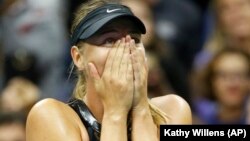 Maria Sharapova reacts after defeating second seed Simona Halep of Romania in their opening round match at the U.S. Open tennis tournament in New York on Monday.