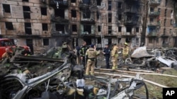 Emergency workers inspect a damaged multi-storey apartment building caused by the latest rocket Russian attack in Kryvyi Rih, Ukraine, Tuesday, June 13, 2023. 