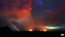 Lava shoots into the night sky from active fissures on the lower east rift of the Kilauea volcano, May 15, 2018, near Pahoa, Hawaii. 
