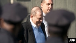 FILE - Harvey Weinstein arrives at the first precinct while turning himself to authorities following allegations of sexual misconduct, in New York, May 25, 2018.