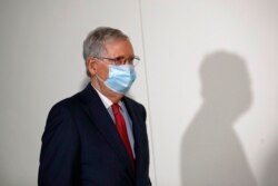 FILE - Senate Majority Leader Mitch McConnell of Kentucky wears a face mask used to protect against the spread of the new coronavirus as he attends a press conference on Capitol Hill in Washington, May 19, 2020.