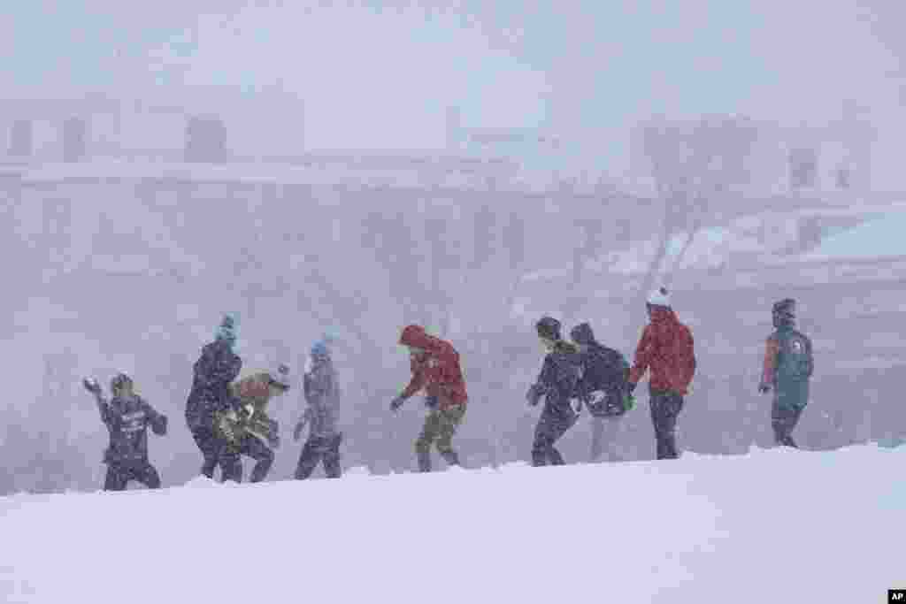 People engage in a snowball fight during a winter snow storm in Washington, Jan. 6, 2025. 