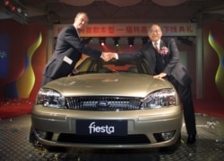 資料照：中國兵器工業集團董事長尹家緒（右）在時任長安汽車高管時與福特公司付執行官瑟斯菲爾德握手。