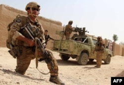 Afghan National Army commandos take position during a military operation in Helmand province, Oct. 2, 2016.