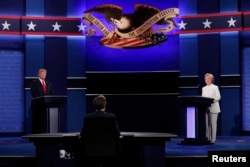 Republican U.S. presidential nominee Donald Trump and Democratic nominee Hillary Clinton begin their third and final 2016 presidential campaign debate at UNLV in Las Vegas, Nevada, U.S., October 19, 2016.