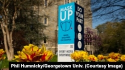 A view of a sign encouraging people to wear masks at Georgetown University earlier in 2021.