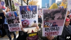 FILE - Demonstrators stage a rally against the recent alleged deployment of North Korean troops to Russia, near the Seoul Central District Court in Seoul, South Korea, Nov. 15, 2024. The signs read "Dismantling North Korea's nuclear weapons."