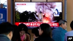 People watch a TV showing a file image of North Korea's missile launch during a news program at the Seoul Railway Station in Seoul, South Korea, Wednesday, Oct. 2, 2019. North Korea on Wednesday fired projectiles toward its eastern sea, South Korea…