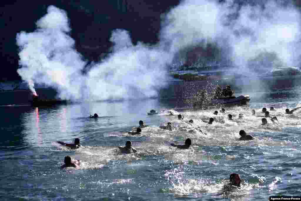 Kosovo Serbs swim in the cold water of Gazivoda Lake as part of the traditional Epiphany swimming competition, near the town of Zubin Potok, in northern Mitrovica.