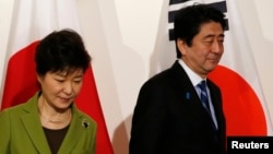 Dancers and drummers begin a celebration of Fèt Gede in the northeast Haitian city of Fort-Liberte. The two-day festival, which overlaps the Christian All Saints Day, honors ancestors. Haitians wear purple, black and white in honor of their forebears. (Jaudelet Junior Saint Vil/VOA)