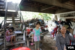 Mom Sinath, a resident in 100 Houses project. The pond in front of her house has not yet been filled yet. (Nov Povleakhena/VOA Khmer)