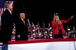 FILE - Sen. Kelly Loeffler, R-Ga., speaks as President Donald Trump and Sen. David Perdue, R-Ga., listen at a campaign rally at Valdosta Regional Airport in Georgia, Dec. 5, 2020.