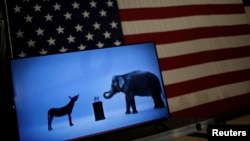 The mascots of the Democratic and Republican parties, a donkey for the Democrats and an elephant for the GOP, are seen on a video screen at Democratic U.S. presidential candidate Hillary Clinton's campaign rally in Cleveland, Ohio, March 8, 2016. 