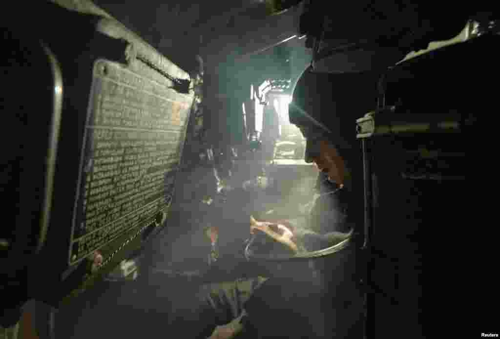 A service member of the Ukrainian armed forces sits inside an armored vehicle at combat positions near the line of separation from Russian-backed rebels in the Donetsk region, Ukraine.