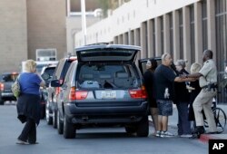 Shooting victim Taylor Stovall gets into a vehicle as her parents Wendy Stovall, far left, and Daniel Stovall, third from left, thank hospital staff University Medical Center in Las Vegas, Nev., on Oct. 3, 2017.