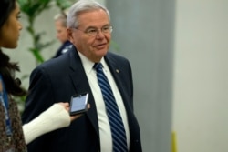 FILE - Senator Bob Menendez talks to reporters on Capitol Hill in Washington, Jan. 28, 2020.