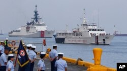 The U.S. Coast Guard National Security Cutter Bertholf (WMSL 750), left, and the Philippine Coast Guard ship BRP Batangas arrive Wednesday, May 15, 2019 in Manila, Philippines, after taking part in a joint exercise off the South China Sea.