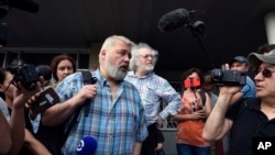 Co-founder and former head of Novaya Gazeta, Dmitry Muratov, foreground, and the Ekho Moskvy (Echo of Moscow) radio station's editor-in-chief, Alexei Venediktov speak to supporters, April 2, 2020.