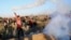 A Palestinian protester throws back a teargas canister that was fired by Israeli soldiers, during clashes on the Israeli border following a protest against U.S. President Donald Trump's decision to recognize Jerusalem as the capital of Israel, east of Gaz