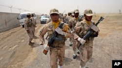 FILE - Iranian border guards march at the eastern border of Iran shared with Pakistan, July 19, 2011. Stability in Baluchistan, the Pakistani province bordering Iran, is considered crucial to implementing the China-Pakistan Economic Corridor, funded by China.