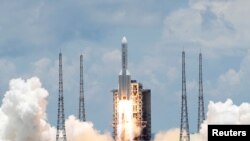 FILE - The Long March 5 Y-4 rocket, carrying an unmanned Mars probe of the Tianwen-1 mission, takes off from Wenchang Space Launch Center in Wenchang, Hainan Province, China, July 23, 2020. 
