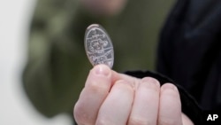 Hunter Kimbel, 7, holds a souvenir penny at the American Dream Mall, March 2, 2025, in East Rutherford, N.J.